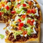 Crescent Roll Taco Pizza topped with cheese, ground beef, and fresh toppings