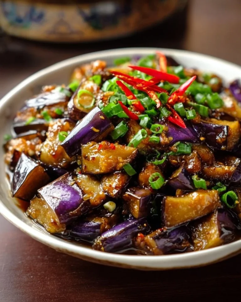 Serving of Chinese eggplant in garlic sauce garnished with herbs and spices