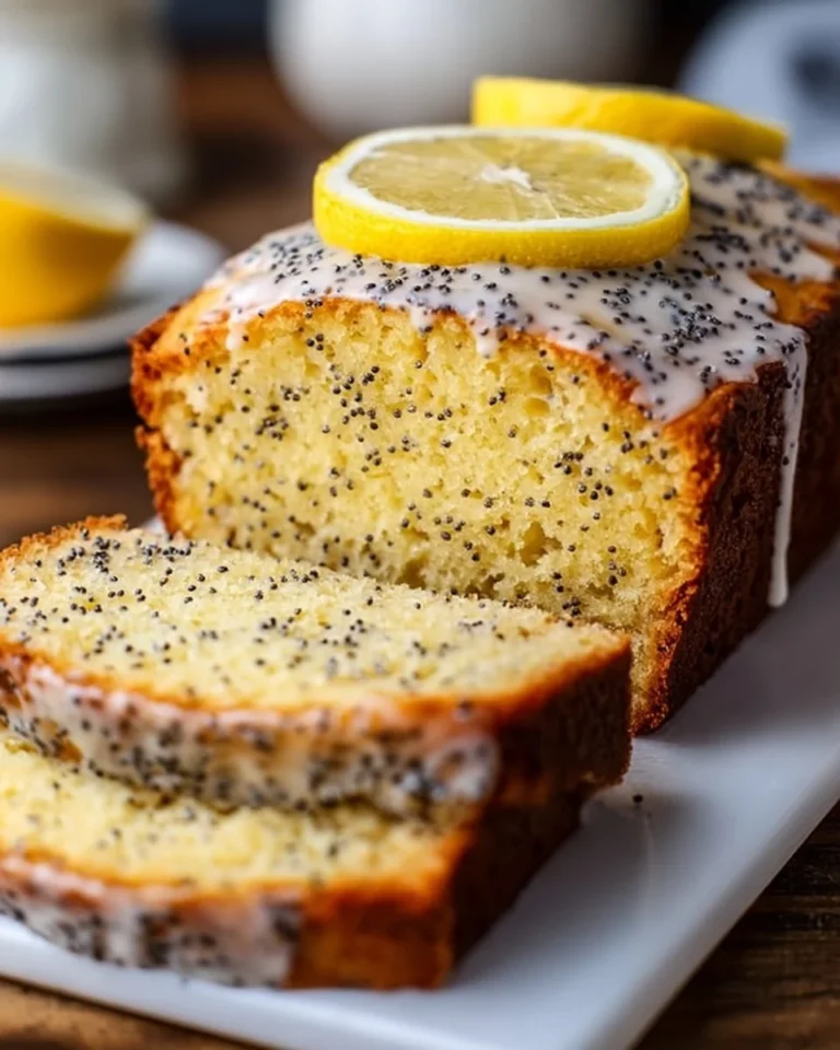 Sliced Classic Lemon Poppy Seed Loaf on a serving platter
