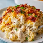 Delicious Crack Chicken Casserole ready to serve, topped with cheese and herbs.