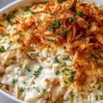 Delicious French onion chicken rice bake topped with melted cheese and herbs