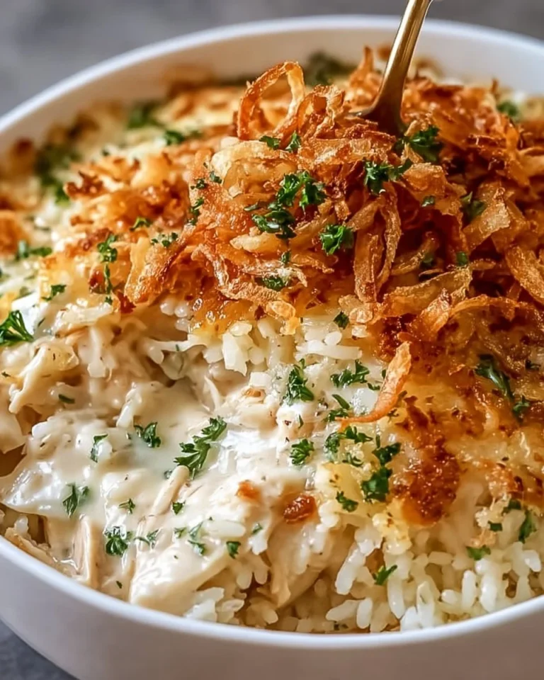Delicious French onion chicken rice bake topped with melted cheese and herbs