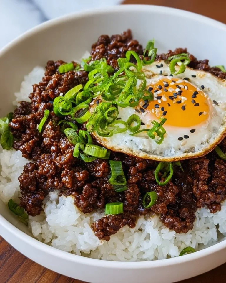 Korean beef bowl featuring tender beef, rice, and colorful vegetables.