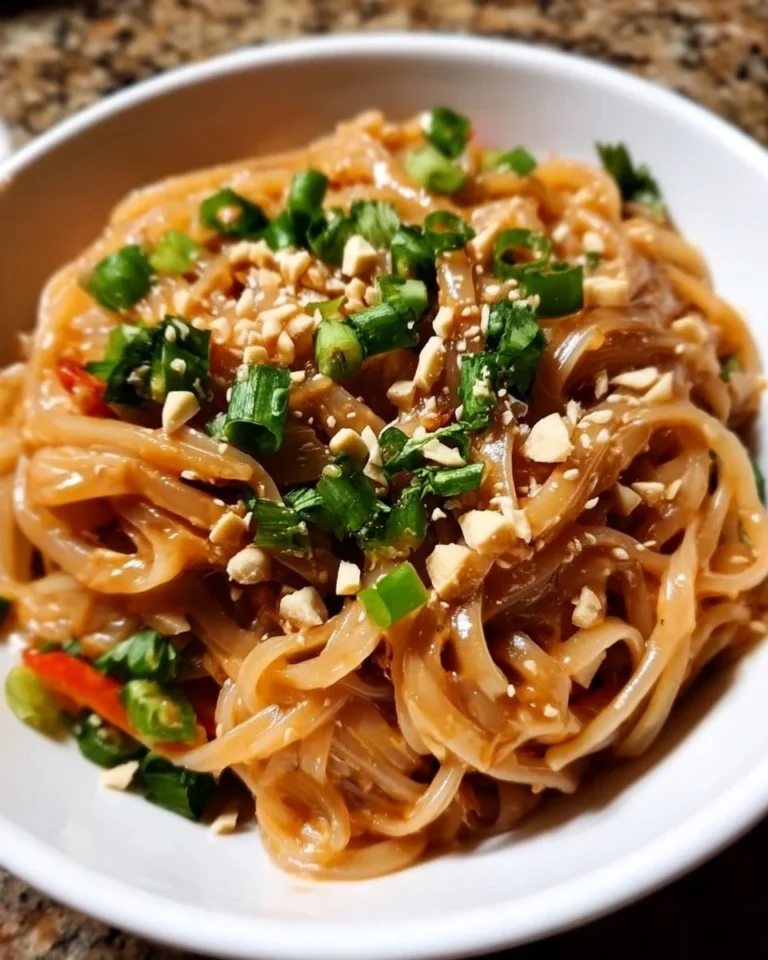 Delicious peanut sauce rice noodles topped with fresh vegetables