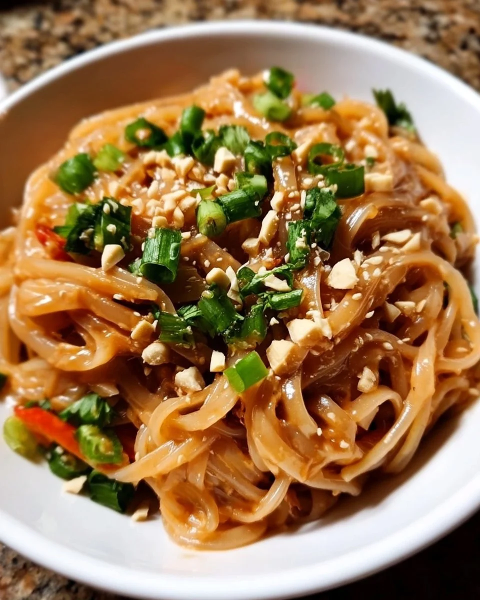 Delicious peanut sauce rice noodles topped with fresh vegetables