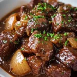 Delicious beef stew cooked in rich onion gravy served in a bowl