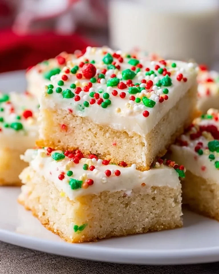 Delicious Christmas sugar cookie bars topped with festive sprinkles