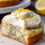 Lemon Poppy Seed Cheesecake Cookies on a white plate garnished with lemon zest