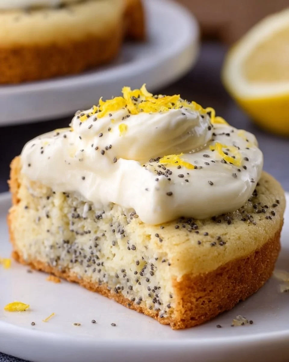 Lemon Poppy Seed Cheesecake Cookies on a white plate garnished with lemon zest