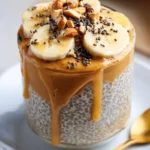 Peanut butter banana chia pudding topped with slices of banana and peanut butter drizzle