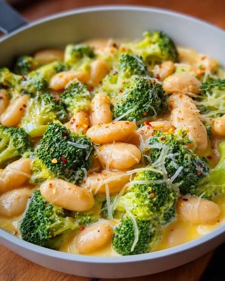 Creamy butter beans with cheese and broccoli in a bowl