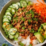 Healthy ground turkey rice bowls topped with colorful vegetables and seasonings