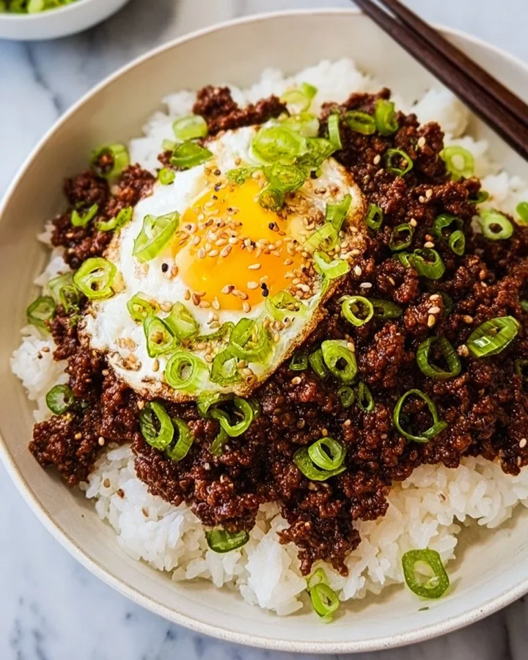 Delicious Korean ground beef bowl topped with fresh vegetables and spices.