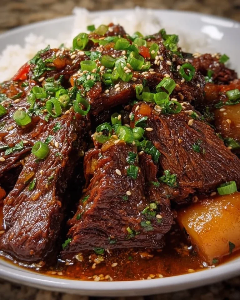 Korean style pot roast served with vegetables and rice on a plate.