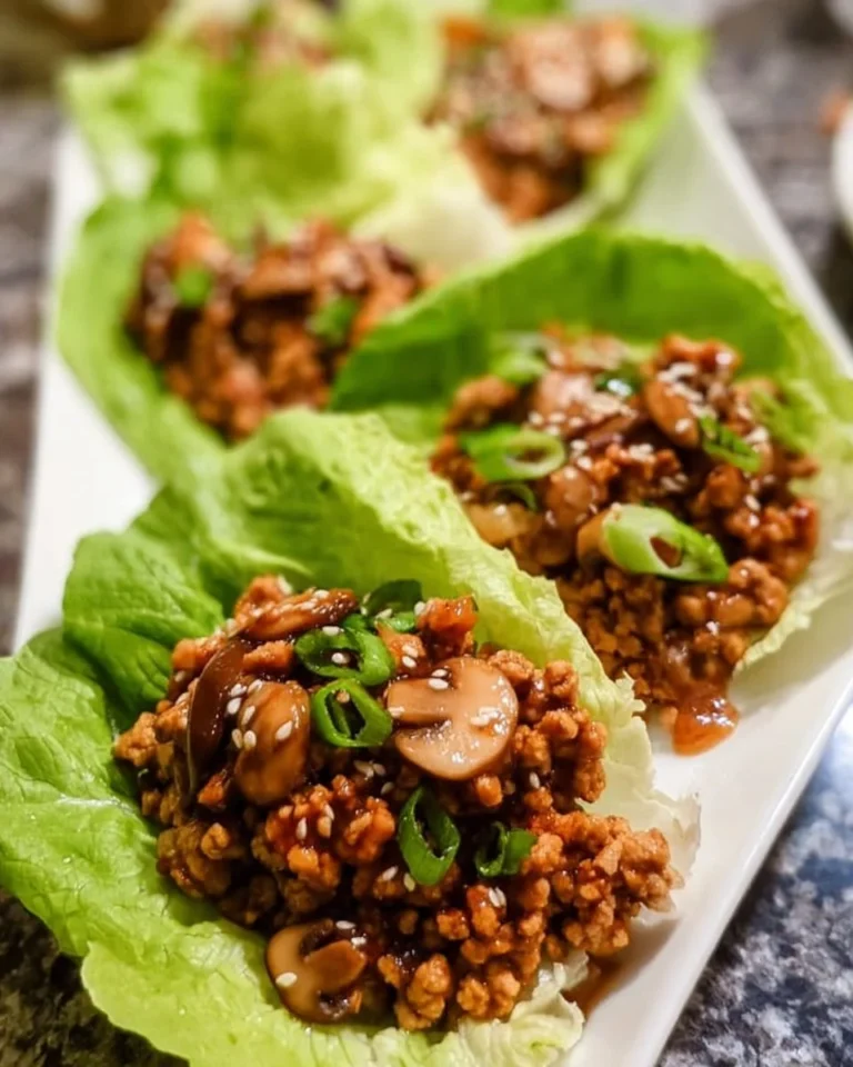 Plate of easy chicken lettuce wraps with vegetables and sauce